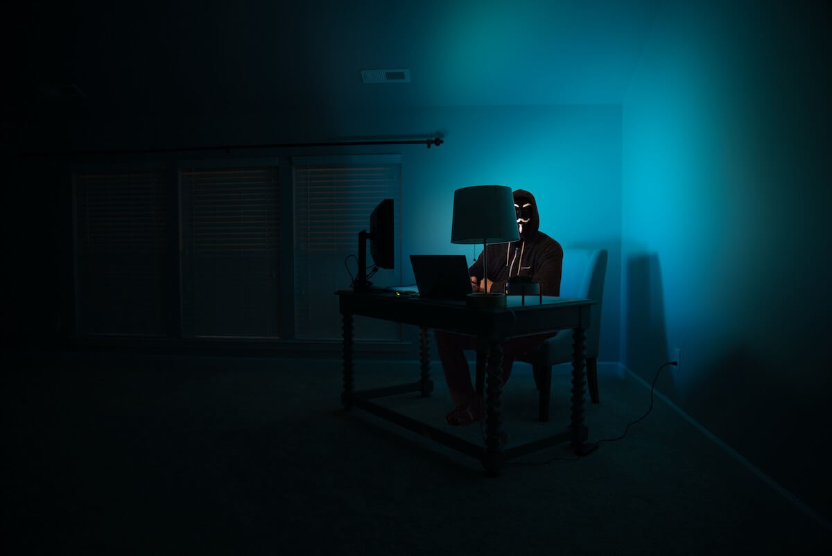 male hacker dressed in black