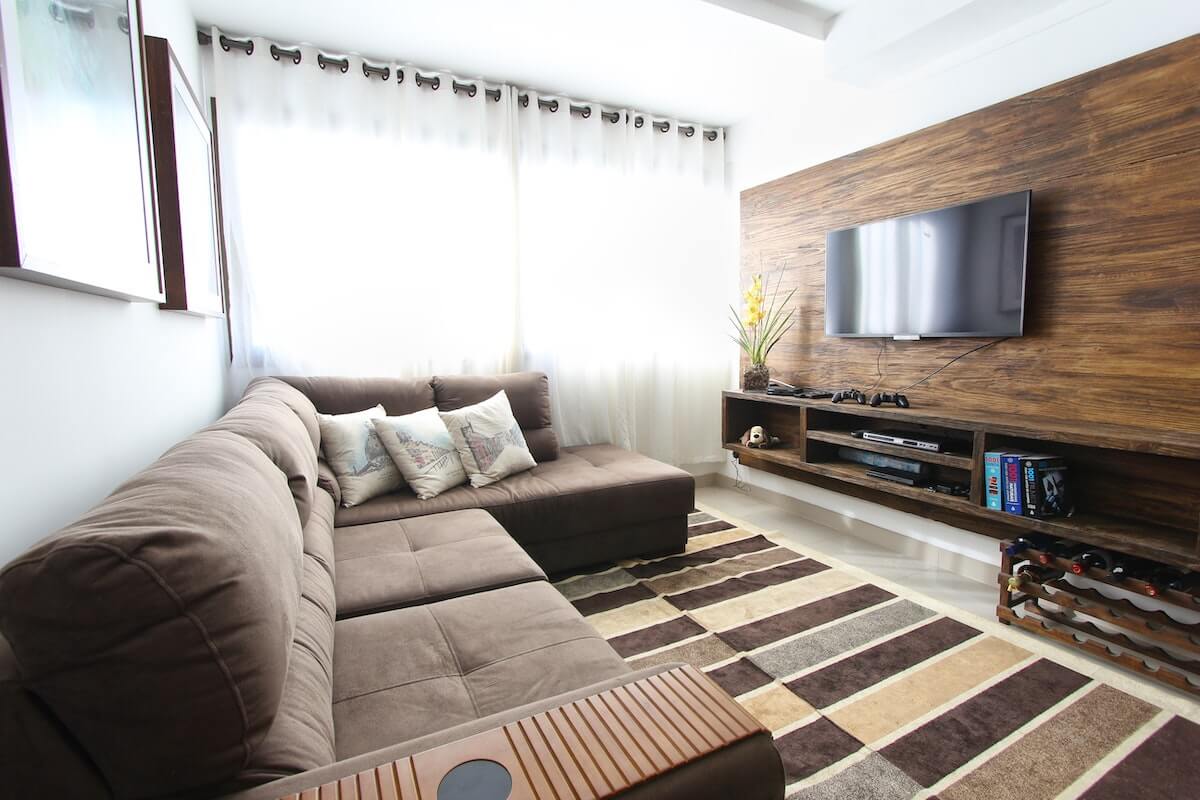 tv room of condo with brown sectional couch