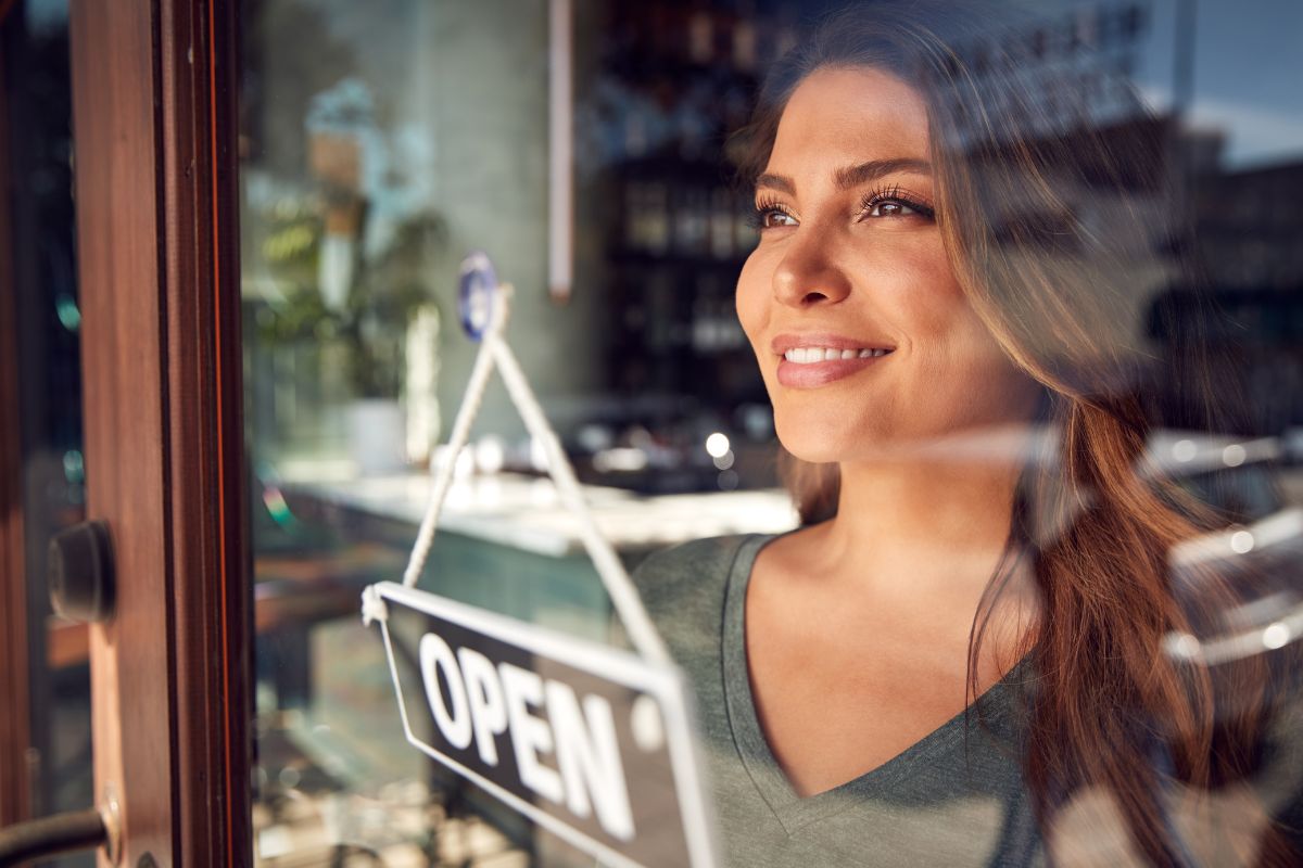 woman with business open sign